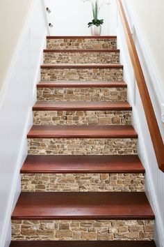 a set of stairs leading up to a vase with flowers in it on the top