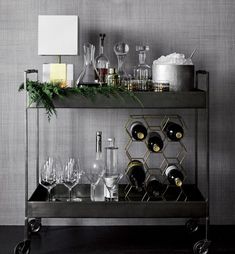 a bar cart filled with glasses and bottles