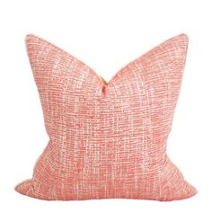 an orange and white pillow on a white background