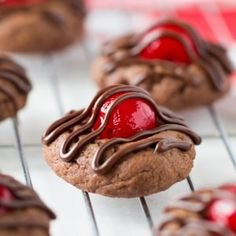 chocolate covered cookies with cherries on a cooling rack, ready to be eaten or eaten