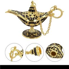 an ornate black and gold teapot with chain attached to the top, on a white background