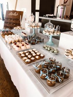 there are many desserts on the table ready to be eaten at this wedding reception