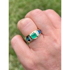 Sleek and classy Colombian Emerald ring with inlaid opals and diamond accents. Emerald-cut Emerald mounted in a 14k half bezel setting. Inlaid Opals provide excellent color contrast to the yellow gold setting and white diamond side stones.   14k solid gold ring and bezel prong setting make for a secure fit that's ideal for daily wear. Hypoallergenic, tarnish-free, and a polished finish for extra shine.      Certificate of appraisal included upon request.   Ring Details:  ✔ Ring Size: 7 U.S. (adj Elegant Green Rings With Inlay, Elegant Green Inlay Rings, Luxury Opal Ring With Bezel Setting For Anniversary, Wide Band Engagement Ring, Colombian Emerald Ring, Half Bezel Setting, Half Bezel, Colombian Emeralds, Yellow Gold Setting