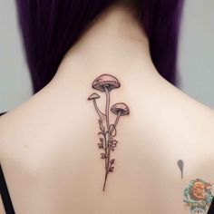 the back of a woman's neck with mushrooms on it