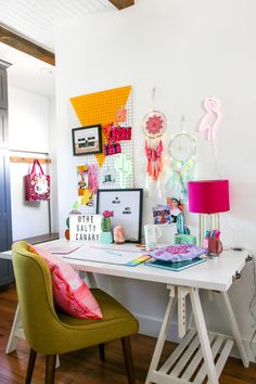 a chair and table in a room with pictures on the wall