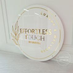 a white and gold sign that says effortless touch