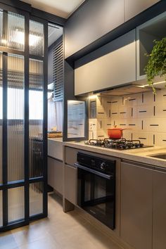 a kitchen with an oven, stove and cabinets