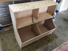 an unfinished cabinet with drawers and tools on the floor