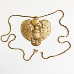 Authentic, Preowned, Vintage D'orlan Egyptian Revival Necklace Of Khepri, Ra, The Winged Scarab, From The King Tut Exhibit, Likely Made In The Mid 1970s. This Is A Quality-Made Vintage Costume Jewelry Piece By D'orlan, Which Was Founded In 1957, And In Later Years Merged With Nina Ricci, Establishing Both Costume And Fine Jewelry Pieces, Typically Found In High End Boutiques And Department Stores. Made From Gold Metal, The Pendant Measures 3in H X 3in W And The Chain Is 24in. Preowned/Vintage With Minimal Signs Of Prior Wear. Stamped D'orlan On The Chain. Scarab Necklace, Winged Scarab, King Tut, Egyptian Jewelry, Egyptian Revival, Department Stores, Vintage Costume Jewelry, Vintage Costumes, Vintage Colors