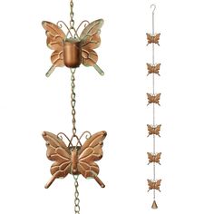 two metal butterflies attached to chains on a white background, one is brown and the other is green