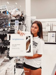 a woman is holding up a sign in a store with the words brightroom on it