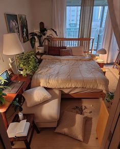 a bedroom with a bed, desk and chair in the corner next to a window