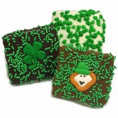 three decorated cookies with green icing and shamrocks on them, one is for st patrick's day