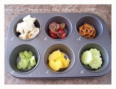 a muffin tin filled with different types of fruit