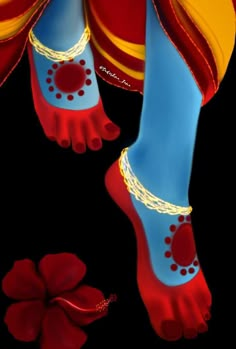 the feet and ankles of a person wearing red, yellow and blue shoes with chains on them