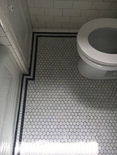 a white toilet sitting next to a bath tub