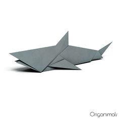 an origami shark is laying on the ground