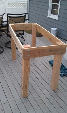 a wooden table sitting on top of a wooden deck