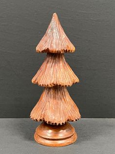 a small wooden christmas tree sitting on top of a table