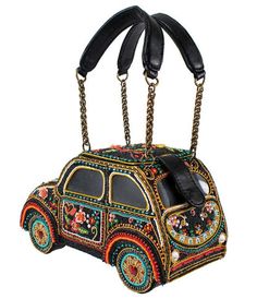 Beep beep! Drive away with the Joyride handbag from Mary Frances. A vibrant masterpiece of hand-laid beads that is as beautiful to display as it is to wear. The bag features beaded flowers and heart designs throughout. Outfitted with an inner pocket, magnetic flap closure, and dual vegan leather handles.This is a Special Order item, please allow a 6-8 week handling time.This is a handmade item, each one an individual work of art. Slight variations may occur.Available while supplies last. Embroidered Handbag, No Strings Attached, Heart Designs, Timeless Classic Style, Halloween News, Leather Handles, Retro Look