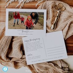 an envelope with a photo and two keys on it next to some other items that include a keychain