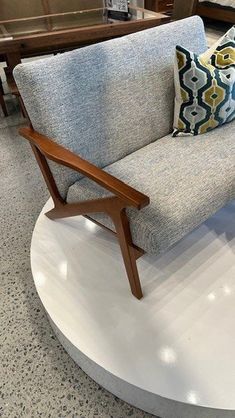 a couch sitting on top of a white circular table