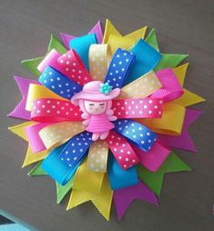 a colorful hair bow with a doll on it