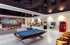 a pool table in the middle of a room with arcade machines and games on the walls