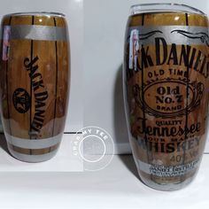 two wooden barrels sitting next to each other on top of a white counter with black writing