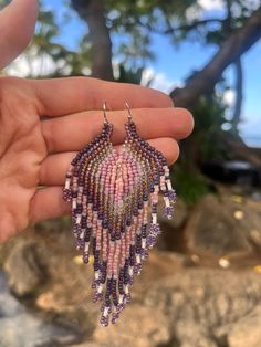 This beautiful pair of boho style earrings with different shades of purple, pink, brown and beige seed beads will bring out the hippie in you! So lightweight and flowy and are perfect for day to day or for any perfect occasion. gift for yourself or for your purple loving friend! Handmade with love using Toho seed beads, each pair is made to order. Approximate measuring: length- 4" width- 0.9" Ear wire is iron and nickel free Purple Bohemian Earrings For Beach, Purple Colorful Beaded Earrings For Festival, Festival Purple Beaded Earrings, Purple Beaded Festival Earrings, Purple Beaded Earrings With Round Beads For Festival, Festival Purple Beaded Earrings With Round Beads, Purple Beaded Earrings For Festival, Handmade Purple Beaded Earrings For Beach, Bohemian Purple Beaded Earrings For Beach