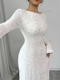 a woman wearing a white lace dress