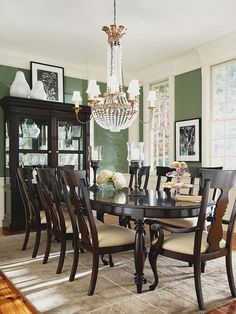 a dining room table with chairs and a chandelier