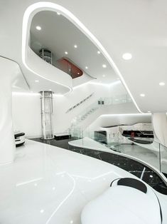 the interior of a modern building with white furniture