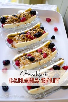 breakfast banana split with berries and granola on top