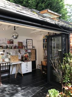 a room with a table and chairs inside of it next to a book shelf filled with books