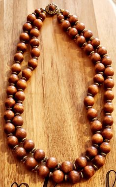 a wooden beaded necklace with the word love written on it