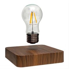 a light bulb sitting on top of a wooden block