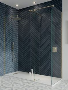 a bathroom with a walk in shower next to a tiled wall and flooring area