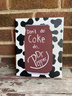 a painted sign that says don't do cake do dr pepper