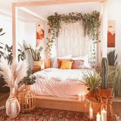 a bedroom with plants and candles on the floor