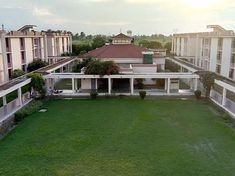 an aerial view of a building with grass in the foreground