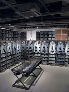 a room filled with lots of metal items in front of a wall full of clothes