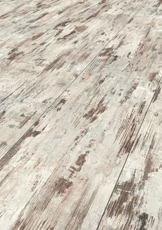 an old wooden floor with faded paint on it's edges and wood grains