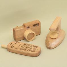 a wooden toy camera and remote control sitting next to each other