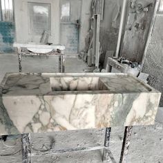 a marble sink in an abandoned room with no one around or looking at the camera