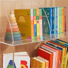 there is a shelf with books on it and many other children's books in the background