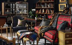 a living room filled with furniture and lots of books