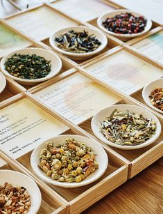 several bowls filled with different types of food on top of a wooden tray next to menus