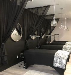 a room with black curtains and mirrors on the wall