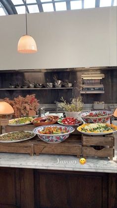 the buffet is full of many different types of food, including salads and sides